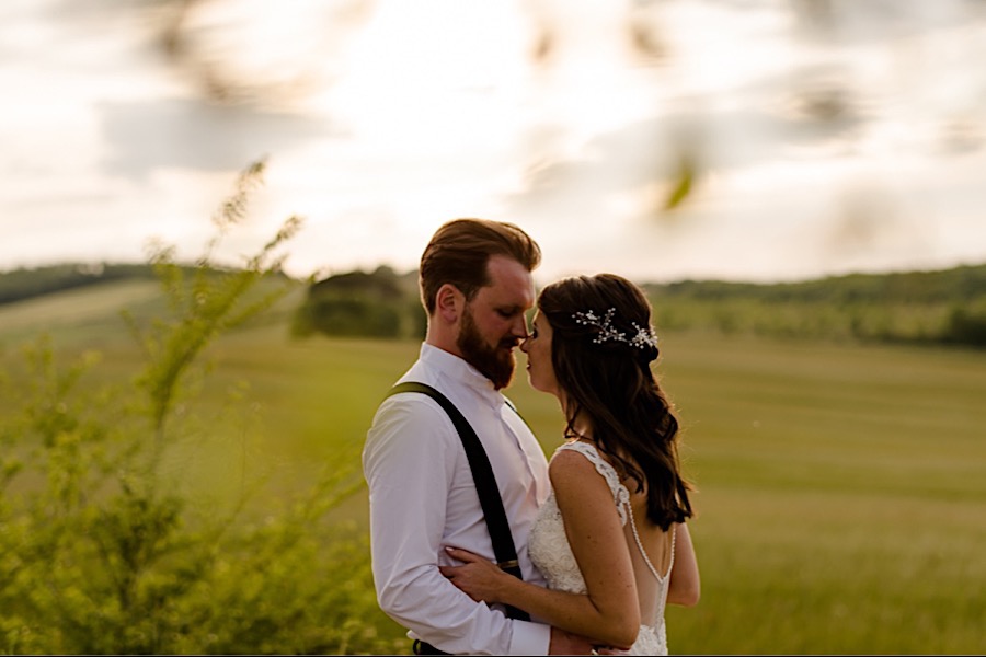 Bride and groom embracing each other on the tuscany hills