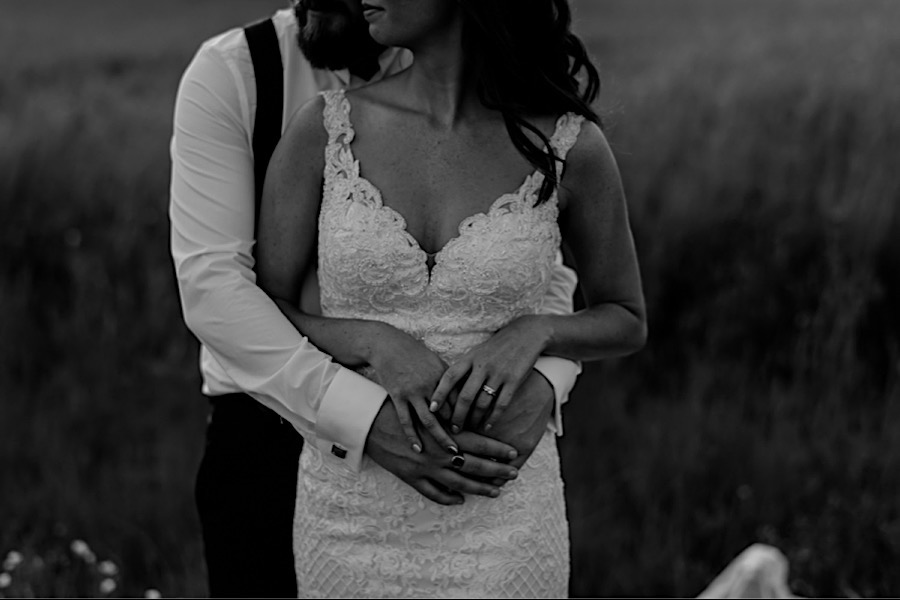 Bride hands and groom hands intimate moment black and white