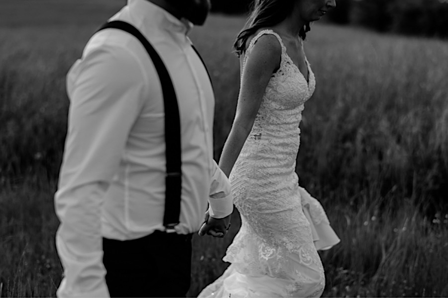 Bride and groom wlaking together black and white