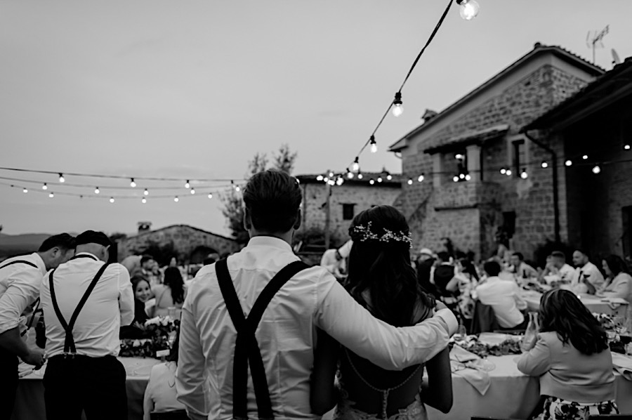 Wedding couple embracing each other during the dinner