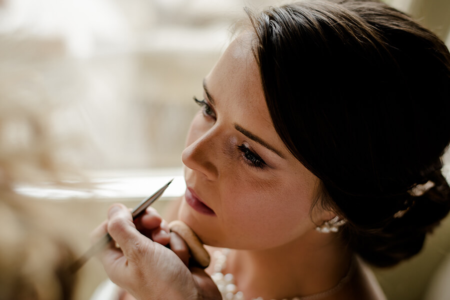 Bride getting ready last touch on the lips