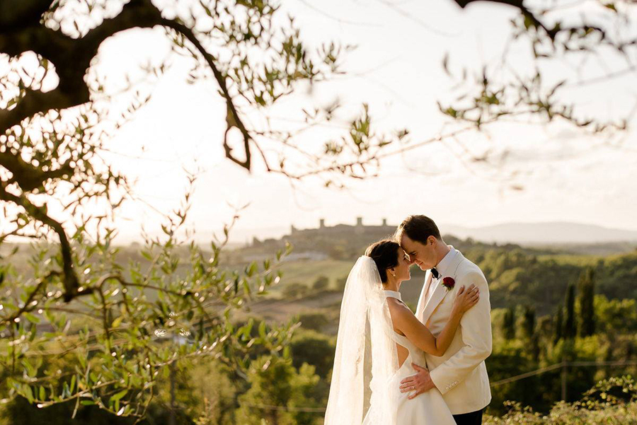 a beautiful wedding couple with monterigigoni in the background