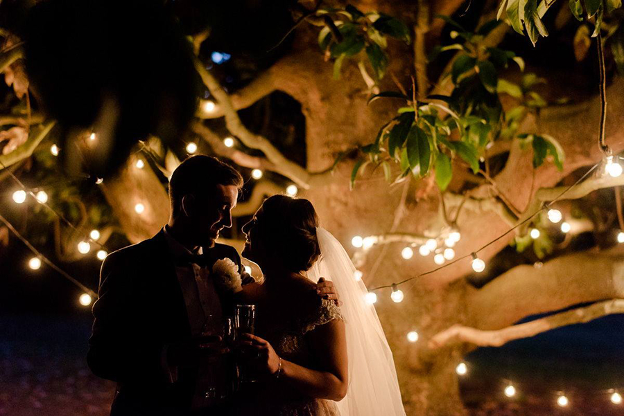 a beautiful couple with the stringlights in tuscany