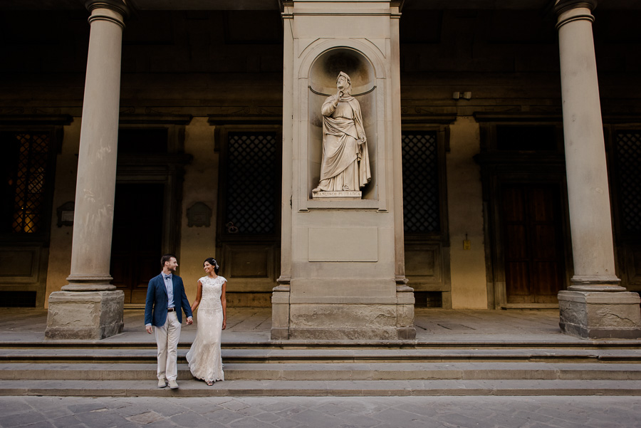 A newlywed couple walking in Florence after they got married