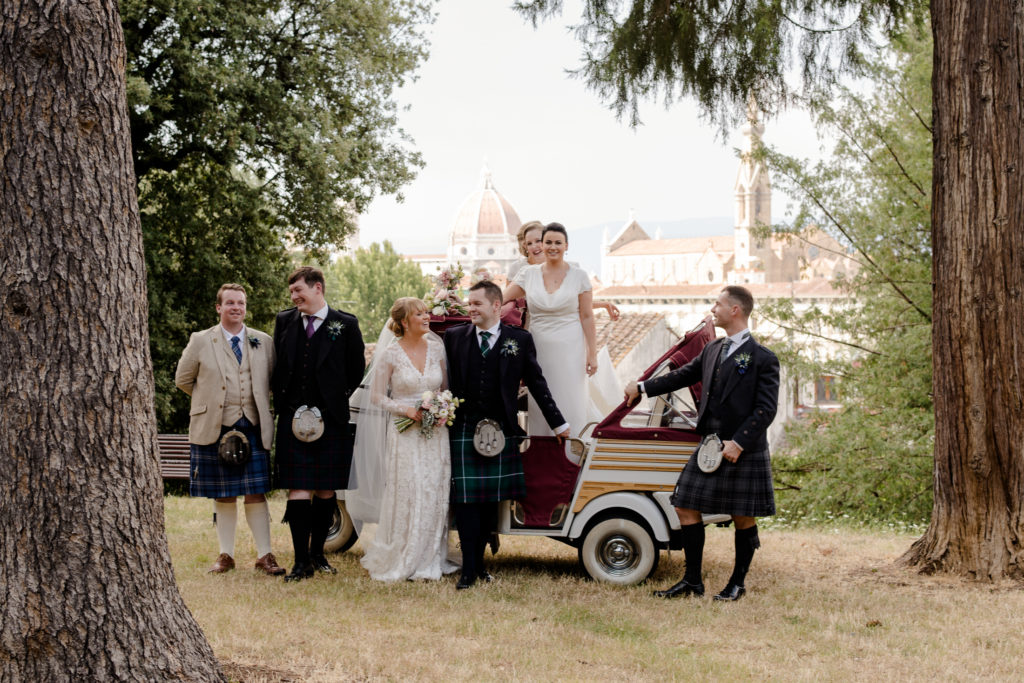 Group photo of bridal party with the view of florence in the background