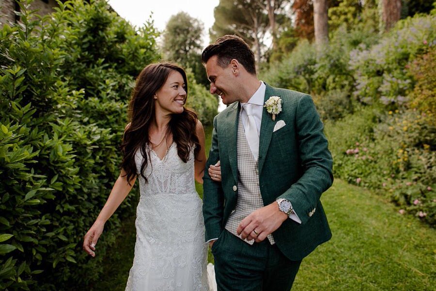 a beautiful wedding couple walking together and looking each other smiling