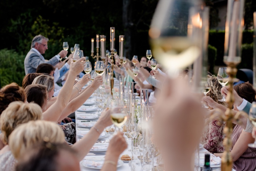 Group toast during a wedding dinner at Tenuta di Pratello Country Resort