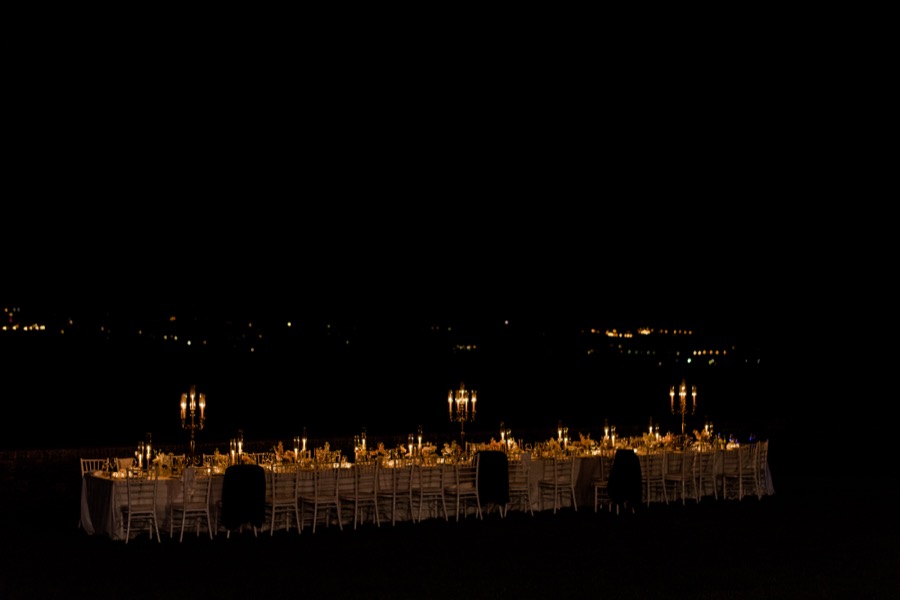 dinner table with candle lighting at night at Tenuta di Pratello Country Resort