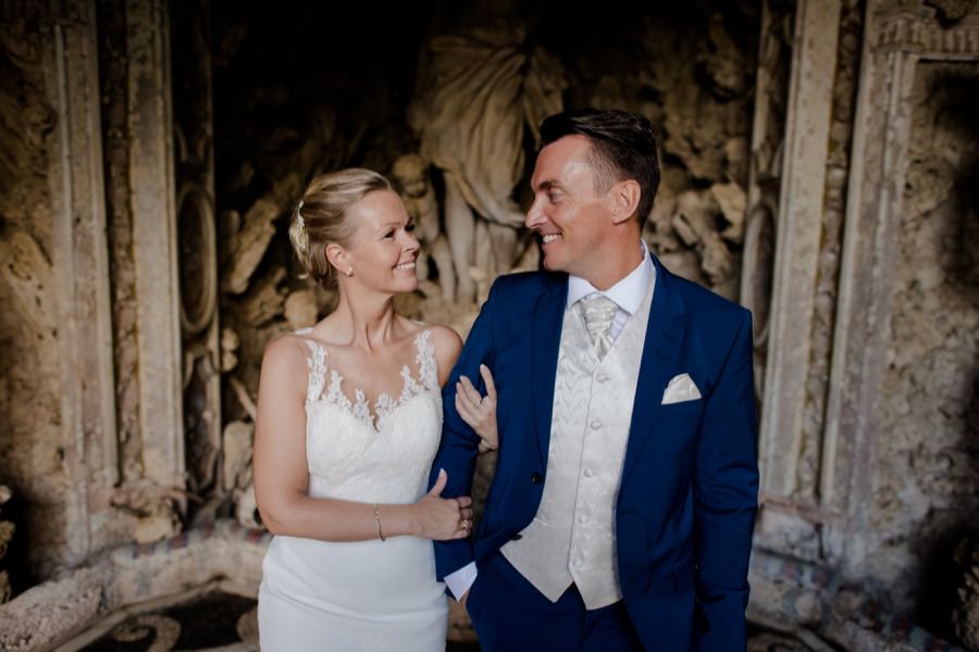 couple smiling and walking at montegufoni castle