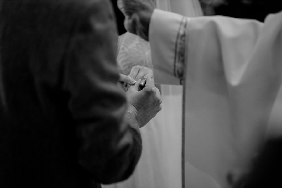 hands details during the exchanging of the rings black and white photo