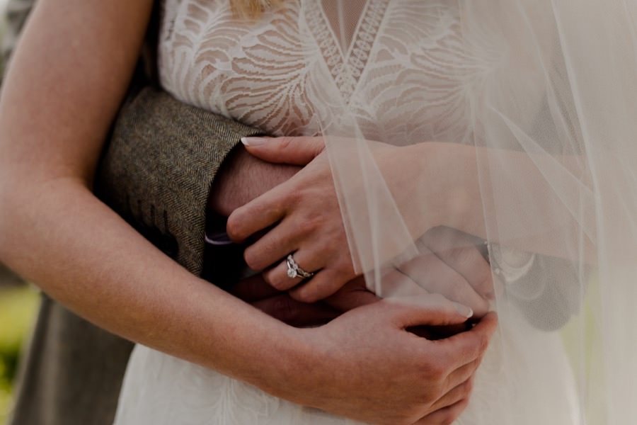 Spouses hands holding each other