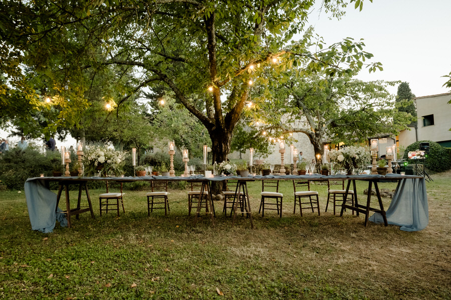 outdoor wedding dinner table setup with greenery