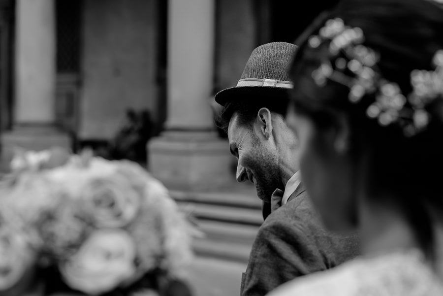 groom with his had candid photo in black and white