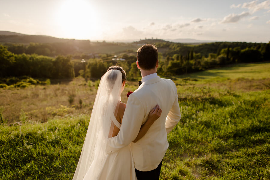 bride and groom portrait from behind with the tuscan landscape