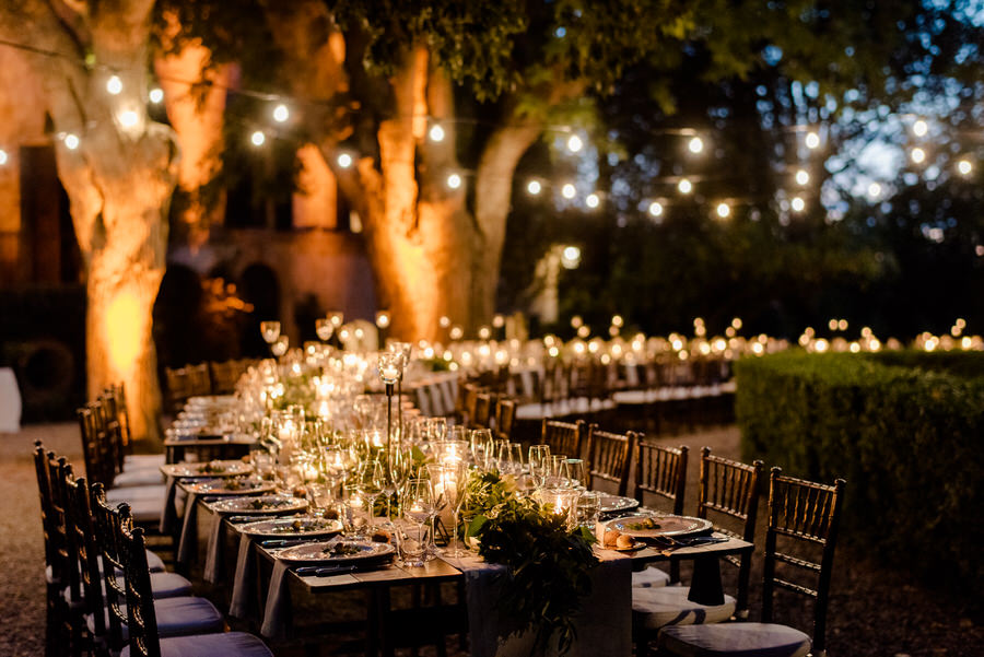 amazing wedding table decorated with flowers, candels and string lights