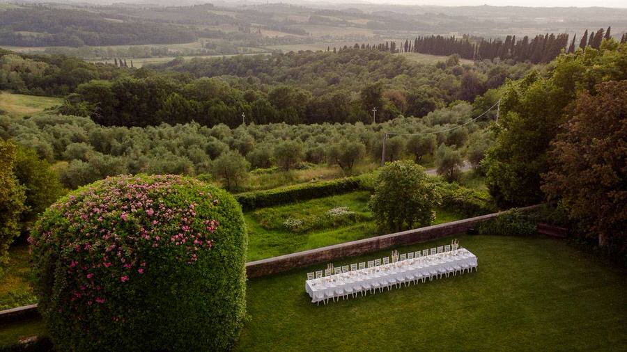 tuscany landscape with a wedding dinner table setting