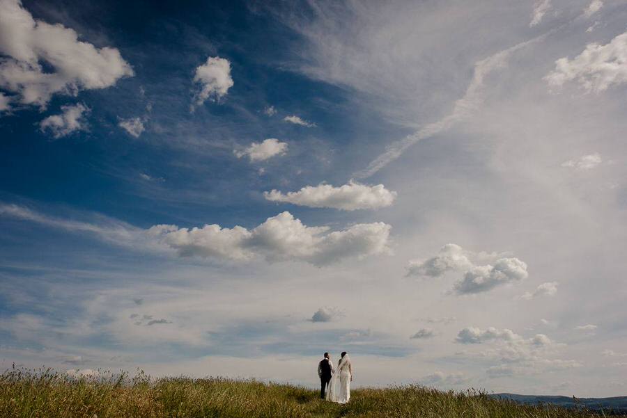 a wedding couple with a blue tuscan sky