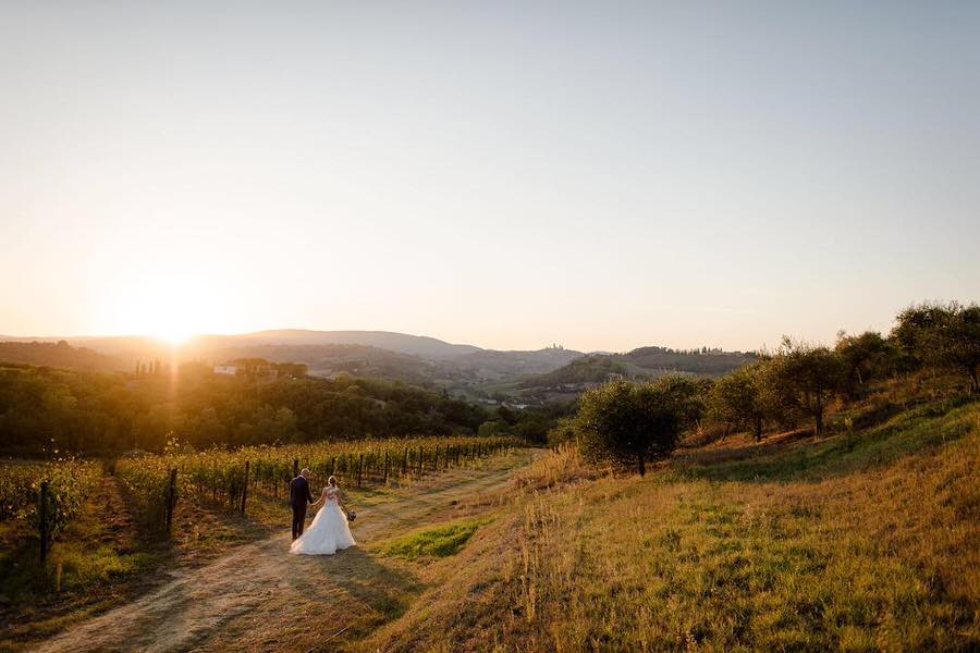 couple walking at the golden hour in Tuscany with a beautiful view