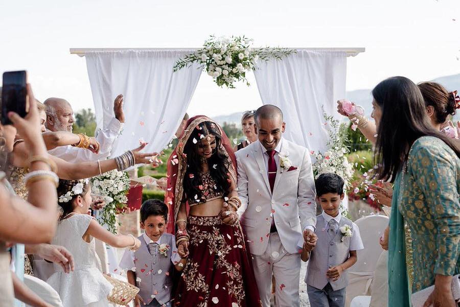 petal toss to Indian wedding couple just married in tuscany