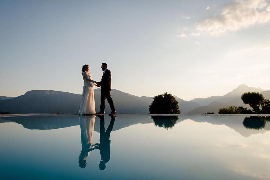 a wedding couple mirrored in the swimming pool in tuscany