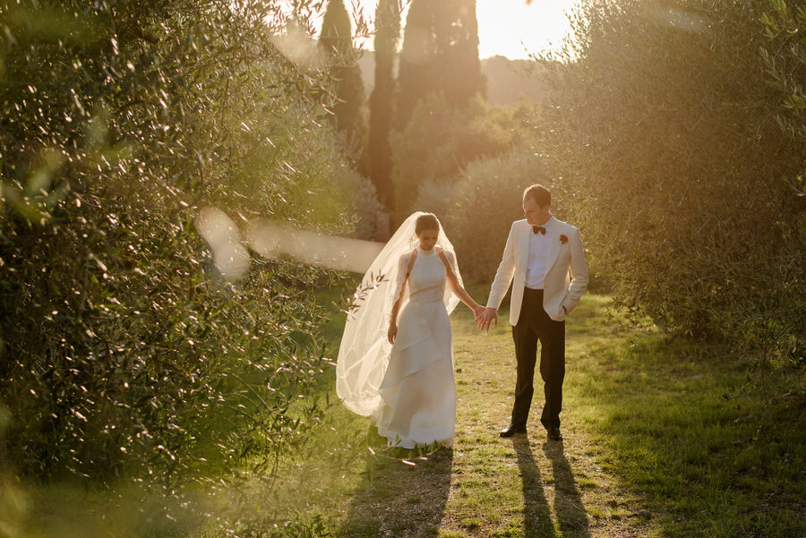 a romantic couple walking at Borgo Stomennano, Monteriggioni, Siena