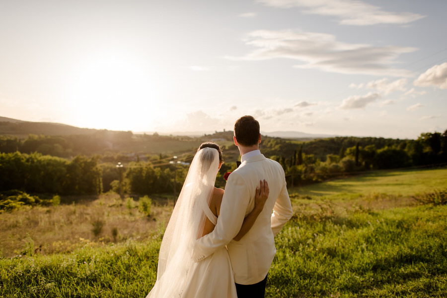 romantic wedding couple looking the landscape at Borgo Stomennano, Monteriggioni, Siena