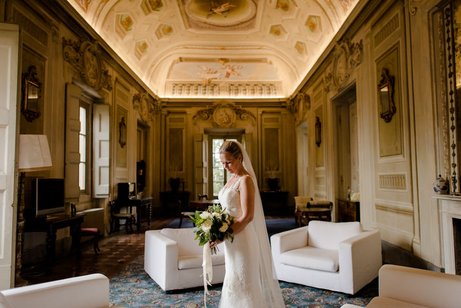 bride dressing her wedding dress in a castle in tuscany