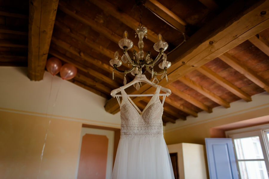 wedding dress hanged on the lamp