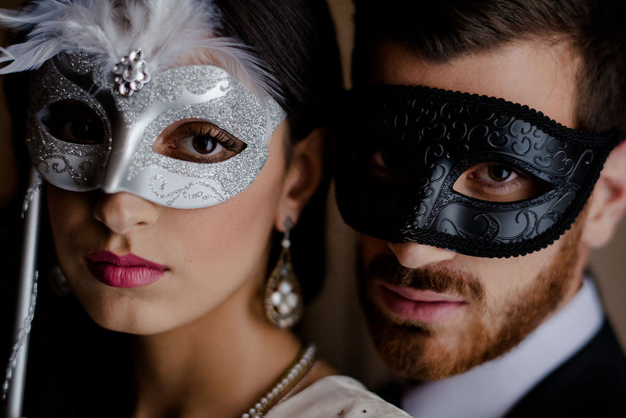 bride and groom with theatrical masks