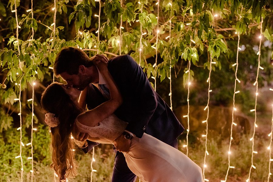 wedding couple kissing with lights